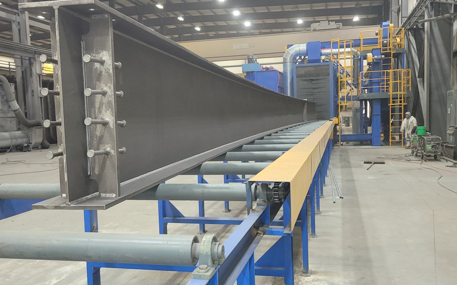 Blasted structural steel girder exiting the automated wheelblast machine at Regal Industrial Pekin