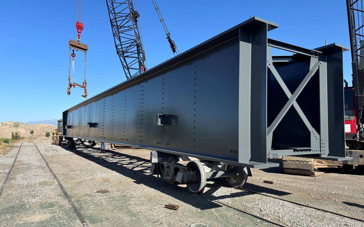 Field metallized plate girder staged on rail car