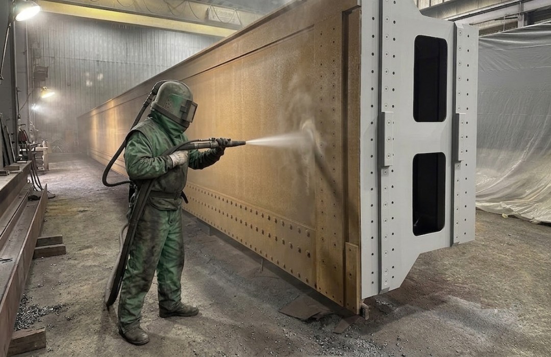 Industrial abrasive blasting of a structural steel girder