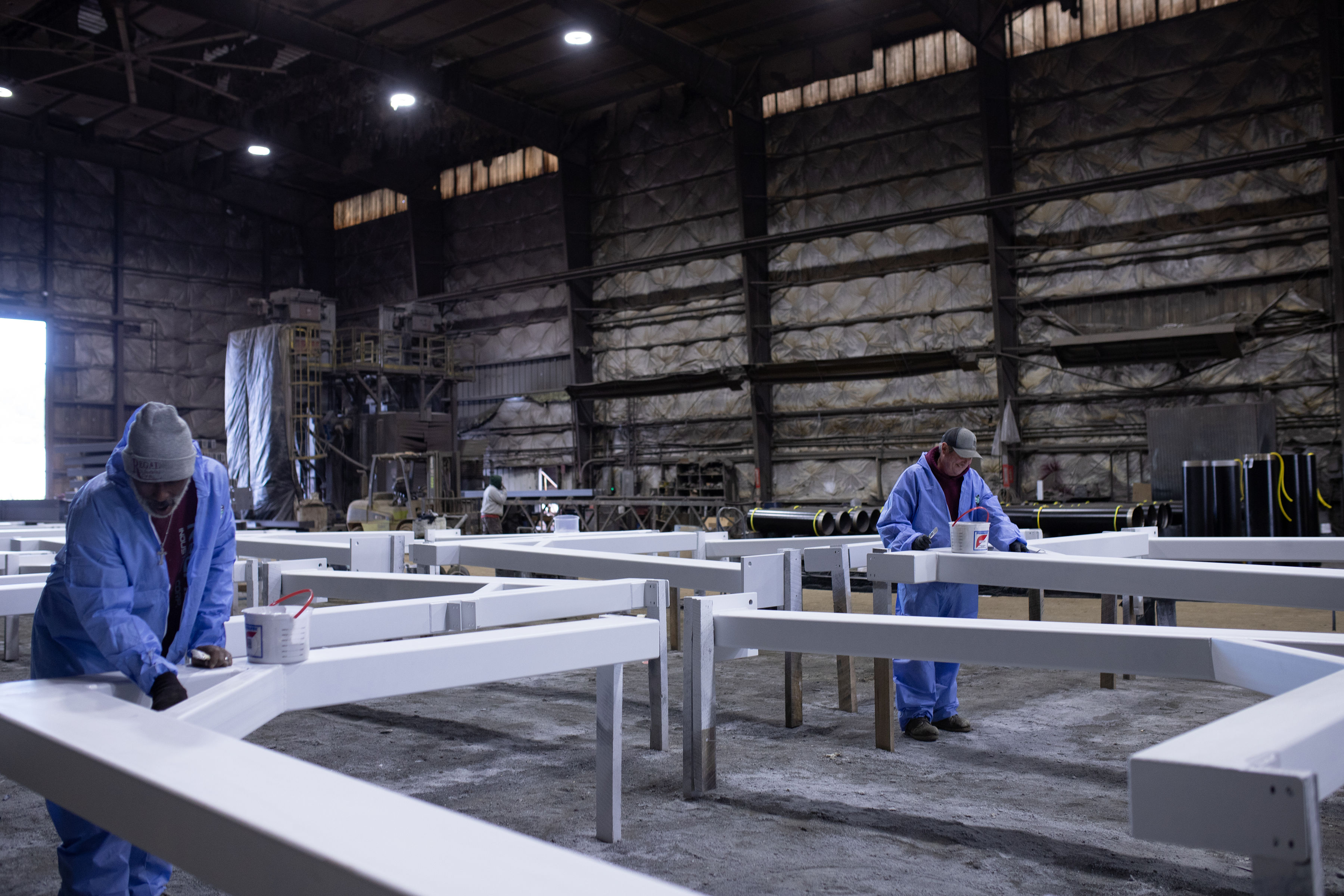 Worker applying thermal spray coating